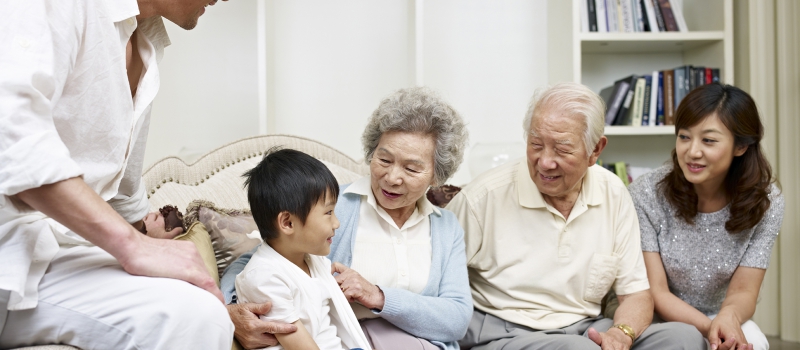 20636318 – three-generation asian family talking in living room